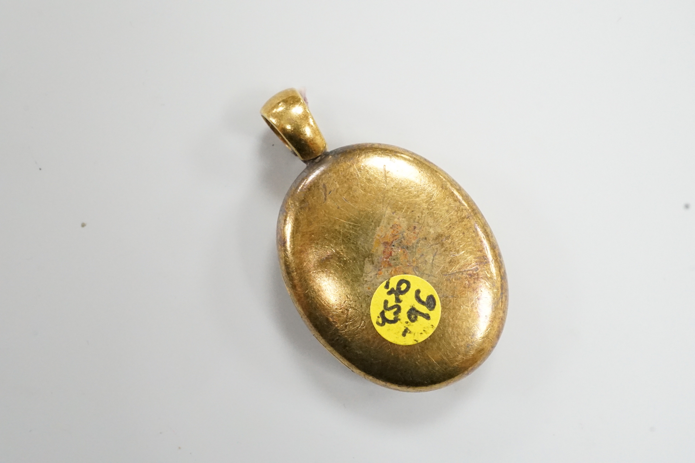 A Victorian yellow metal and enamelled oval locket, 39mm, gross weight 13.2 grams.